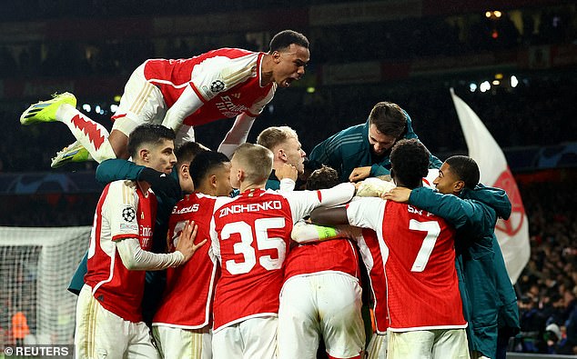 Gunners players swarmed to Raya after the Spaniard kept their Champions League hopes alive