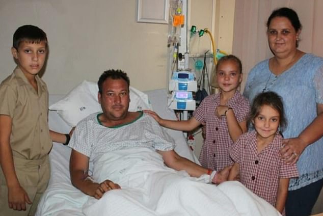 Dad-of-three Anthony Joubert (pictured recovering with his family) was rescued by his brave wife after she went into the water with a log and punched the crocodile around its head until it 'slid away'