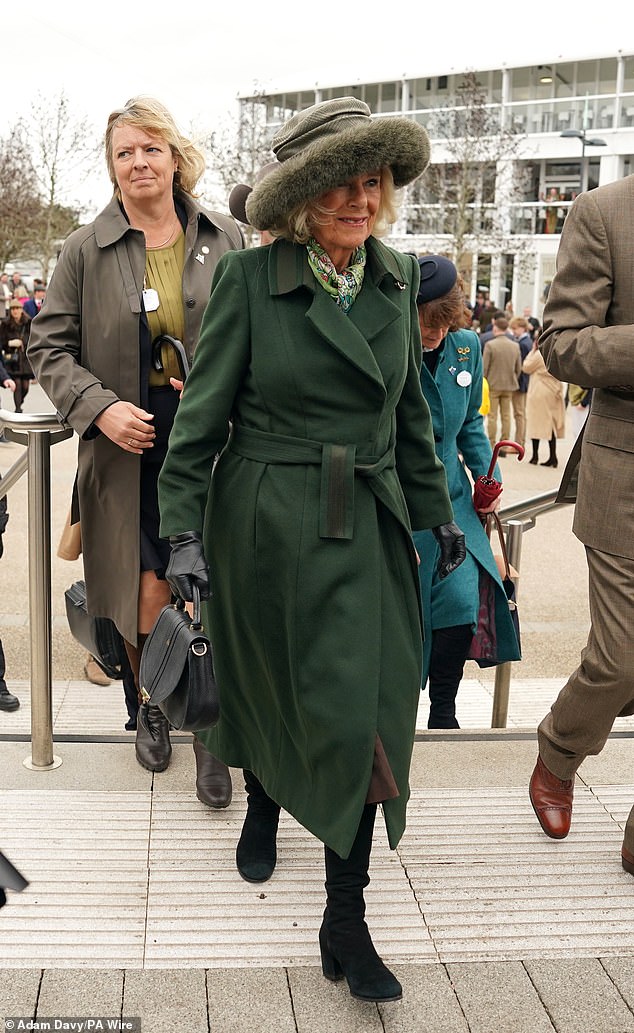 Camilla's structured coat featured a tie belt at the waist and a colorful green patterned scarf, plus black knee-high suede boots