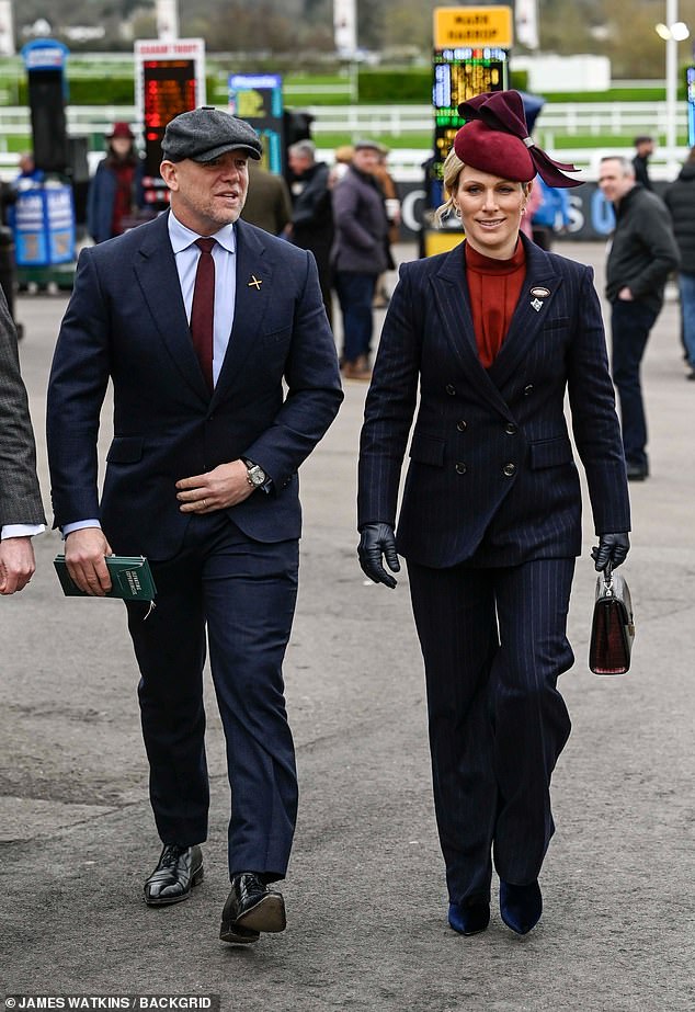 Mike Tindall looked dapper in a navy suit, gray cap and a burgundy tie that perfectly matched his wife's fascinator