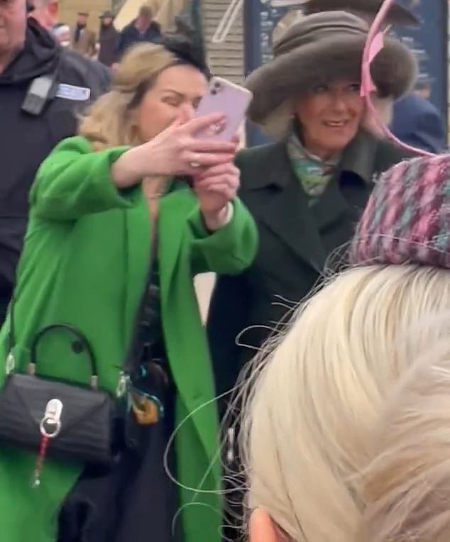 Shortly after addressing the Queen, the woman was seen chatting with the royal family before pulling out her phone and taking a selfie