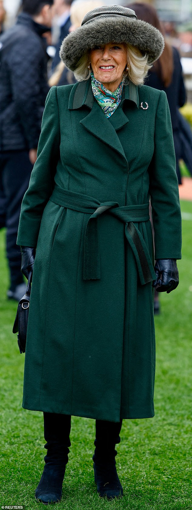 Camilla wore a green structured coat and furry gray hat today to protect herself from the gloomy weather at the event