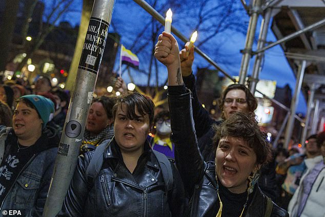 People sing during a vigil for the death of Nex Benedict outside the Stonewall Inn in New York