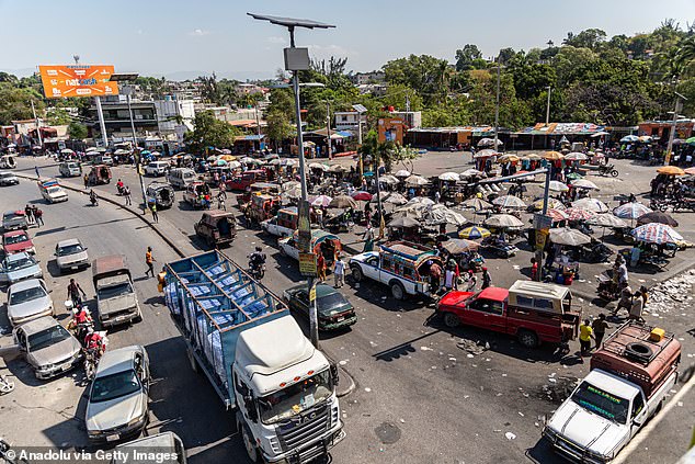 Another 39 officers from the Florida Department of Law Enforcement, 30 from Florida Highway Patrol and 23 from the Florida Fish and Wildlife Conservation Commission will also join, as well as aircraft and drones and eight boats.  Pictured: Port-au-Prince, Haiti, Monday