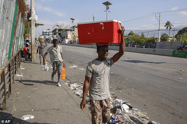 “We cannot allow illegal aliens to come to Florida,” DeSantis concluded Wednesday, claiming that current Coast Guard defenses along the state's southern coast are “under-resourced.”  In the photo: dispossessed people walk through a street in Port-au-Prince on Tuesday