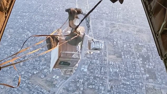 The life-saving supplies are pushed out of the back of the military aircraft in the photo above