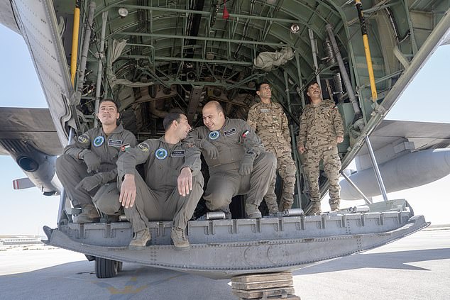 Jordanian pilots take a break between loading humanitarian aid onto a C-130 at King Abdullah II Air Base