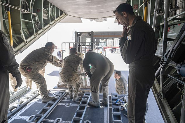 Jordanian pilots load relief supplies bound for Gaza into a C-130 at King Abdullah II Air Base