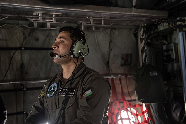 A member of the Jordan Royal Air Force prepares the plane for departure.  The cargo was dropped over Gaza