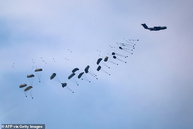 This photo taken from Israel's southern border with the Gaza Strip shows humanitarian aid being dropped over Palestinian territory on March 13, 2024.