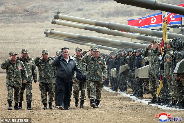 Troops salute North Korean leader Kim Jong-un during their military demonstration involving tank units