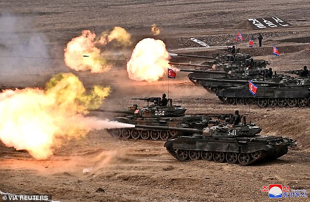 Tanks shoot during the military demonstration attended by Kim Jong Un