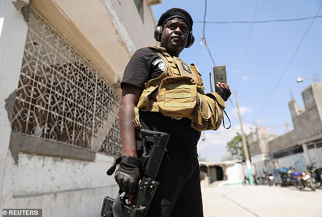 Former police officer Jimmy 'Barbecue' Cherizier (pictured) warned of a 'genocide' unless Haiti's Prime Minister Ariel Henry resigns.  He resigned on Monday