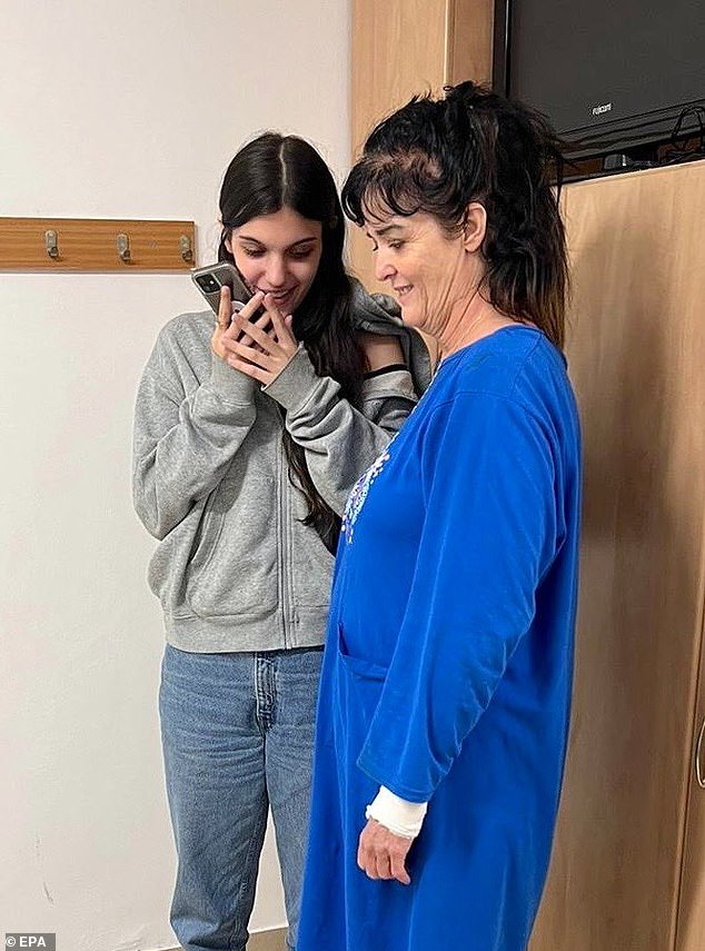 In a handout photo made available by the US Embassy in Jerusalem on their official X account on October 21, US citizens Judith Raanan (R) and daughter Natalie Raanan (L) are seen on the phone with US President Joe Biden ( not pictured) after their release after being kidnapped by Hamas in Israel, early October 21, 2023