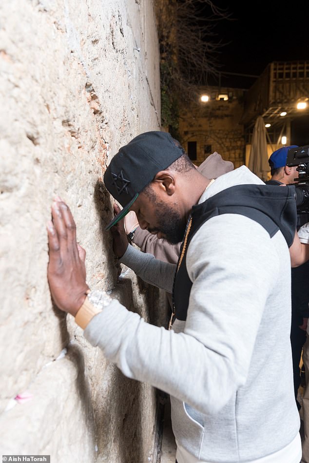 The 50-0 fighting legend was seen praying for peace at the Western Wall during his visit