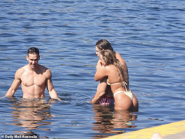 They were also joined by their co-star Jono McCullough as they all stripped down to their swimwear for a cooling dip in the sea.