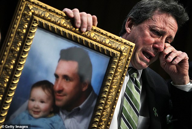 Neil Heslin, father of six-year-old Sandy Hook Elementary School victim Jesse Lewis, wipes away tears as he testifies during a hearing before the Senate Judiciary Committee