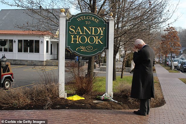 Steve Wruble stands silent and thoughtful at the Sandy Hook town sign after the Sandy Hook Elementary School shooting, Newtown, Connecticut, USA.  December 15, 2012