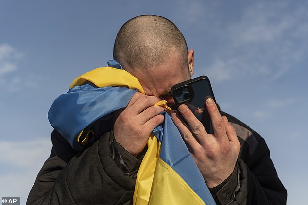 FILE - A recently exchanged Ukrainian prisoner of war cries as he calls his relatives after a prisoner exchange at the Ukrainian-Russian border, on Wednesday, January 31, 2024