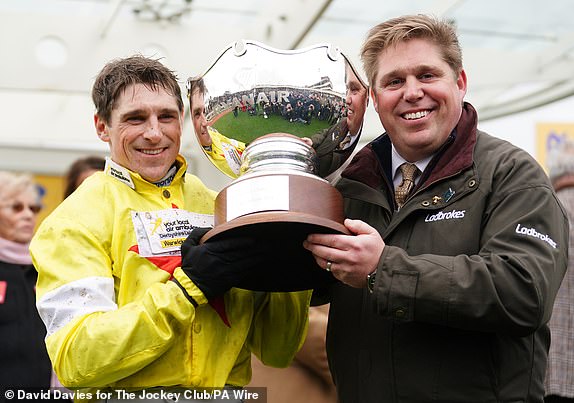 Harry Skelton and Dan Skelton lift the trophy after winning the Ryanair Steeple Chase with Protektorat on day three of the 2024 Cheltenham Festival at Cheltenham Racecourse.  Date of photo: Thursday, March 14, 2024. PA Photo.  See PA story RACING Cheltenham.  Photo credit should read: David Davies for The Jockey Club/PA Wire.  RESTRICTIONS: Editorial use only, commercial use subject to prior permission from The Jockey Club/Cheltenham Racecourse.