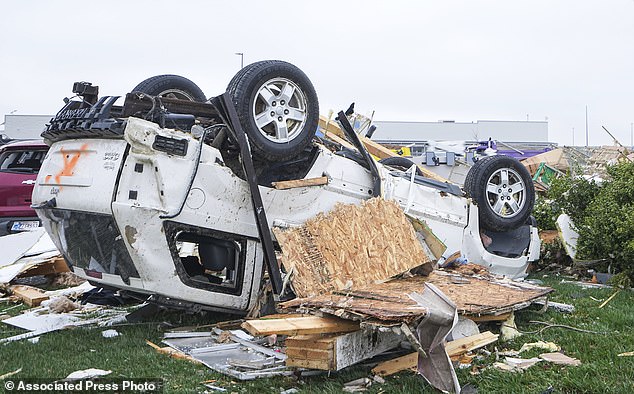 Cars are damaged by heavy storms on Friday, March 15, 2024 in Winchester, Indiana.  Severe storms with suspected tornadoes have damaged homes and businesses across the central United States.  (Grace Hollars/The Indianapolis Star via AP)