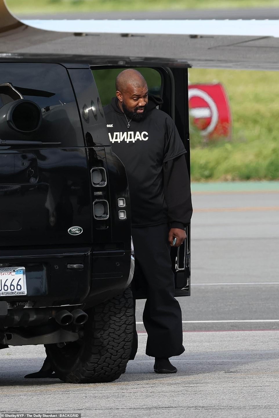 The Vultures hitmaker stood by the car door as he waited for the rest of his crew to follow him