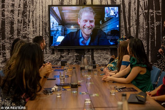 Harry appeared to be in a building resembling a ski chalet as he delivered a video message to the recipients of the Diana Legacy Award on Thursday