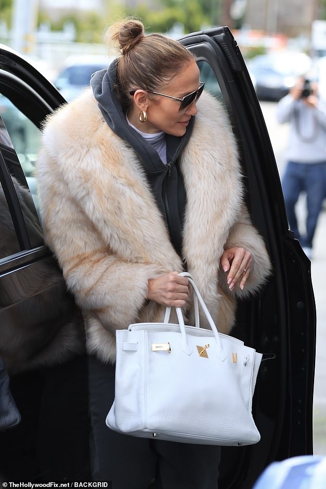 The 54-year-old multihyphenate balanced a casual look with luxury as she wore a brown and white fur coat with a steel blue jogging suit