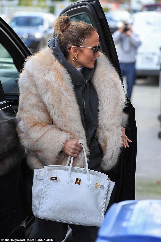 She was carrying a white Hermés handbag, which costs between $30,000 and $100,000.