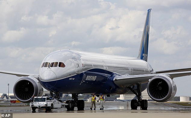 A file photo shows Boeing employees walking the company's new flagship 787-10 Dreamliner to the delivery pad at the company's South Carolina factory