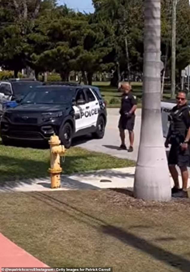 Miami police officers are seen on the scene outside Carroll's home