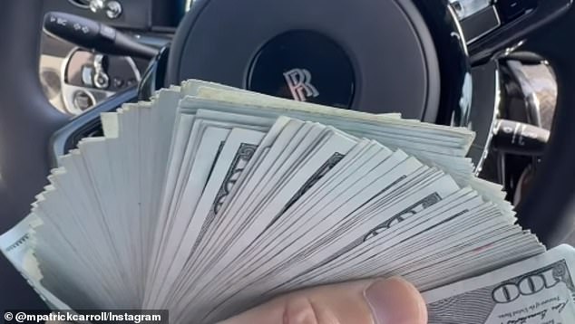 Carroll fans a wad of hundred-dollar bills as he sits in his Rolls Royce