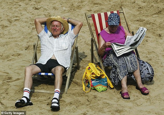 Elderly couple enjoy the sun on Blackpool beach in August 2003