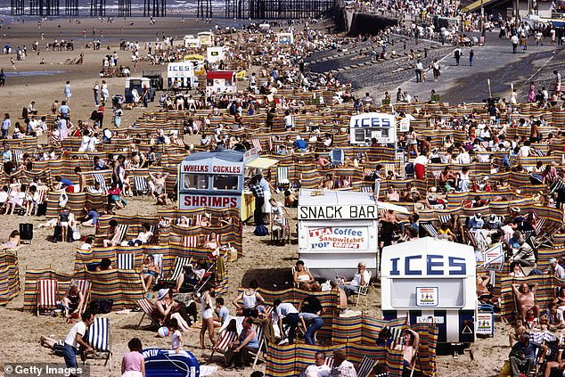 Crowds of holidaymakers and kiosks offering tea, coffee, ice cream, whelks, cockles and prawns on Blackpool beach in August 1983