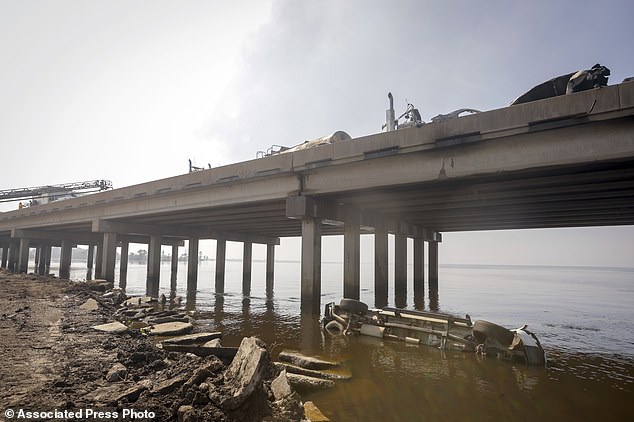 A vehicle is seen in the water under Interstate 55 near Manchac