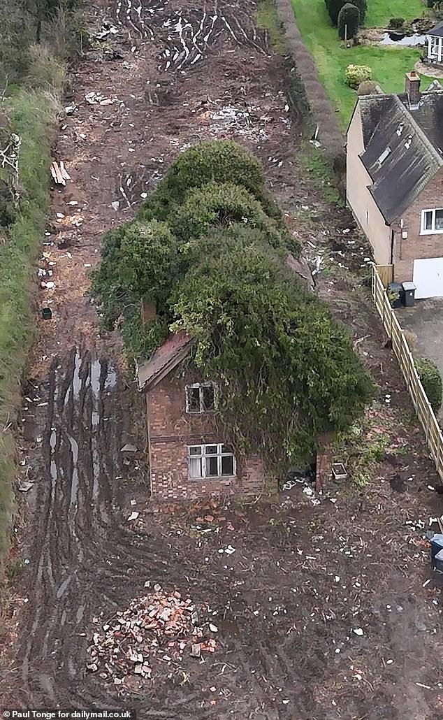 An aerial view reveals the drastic work underway to clear the land surrounding the property