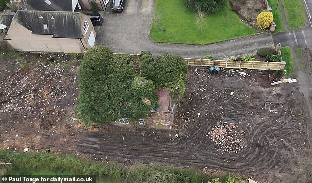 An aerial photo shows that the thick undergrowth still covers almost the entire house