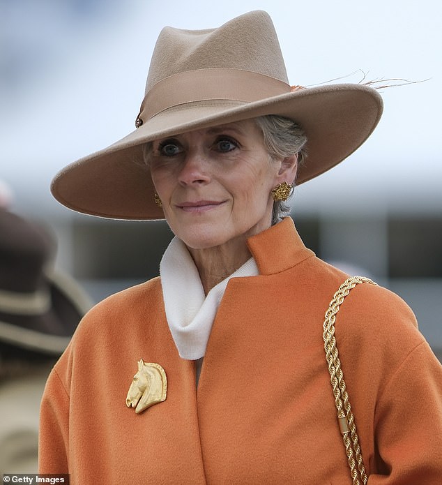 All about the accessories: One woman wore a gold horse brooch to complete her elegant ensemble