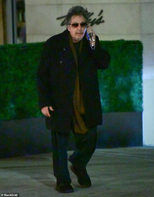 The Oscar winner looked relaxed in a warm black wool coat over a sweater and black sweatpants