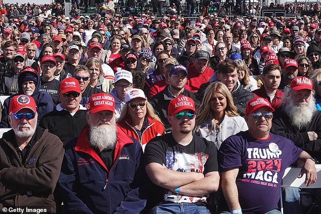 Guests listen as Republican presidential candidate, former President Donald Trump, addresses supporters during a rally at Dayton International Airport