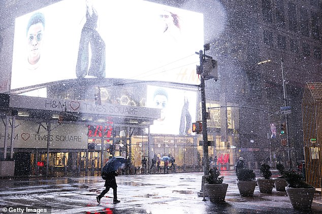 El Niño – which translates to “little boy” in Spanish – is caused by a shift in the distribution of warm water in the Pacific Ocean around the equator.  Pictured: People walk past Times Square during a winter storm in February