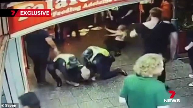 Police officers claim they were spat at when they arrived on the scene and tried to break up the brawl just before 1am