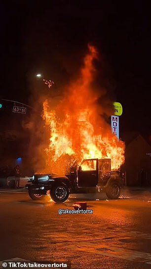 The vehicle burned in the middle of the street while another car did donuts around it