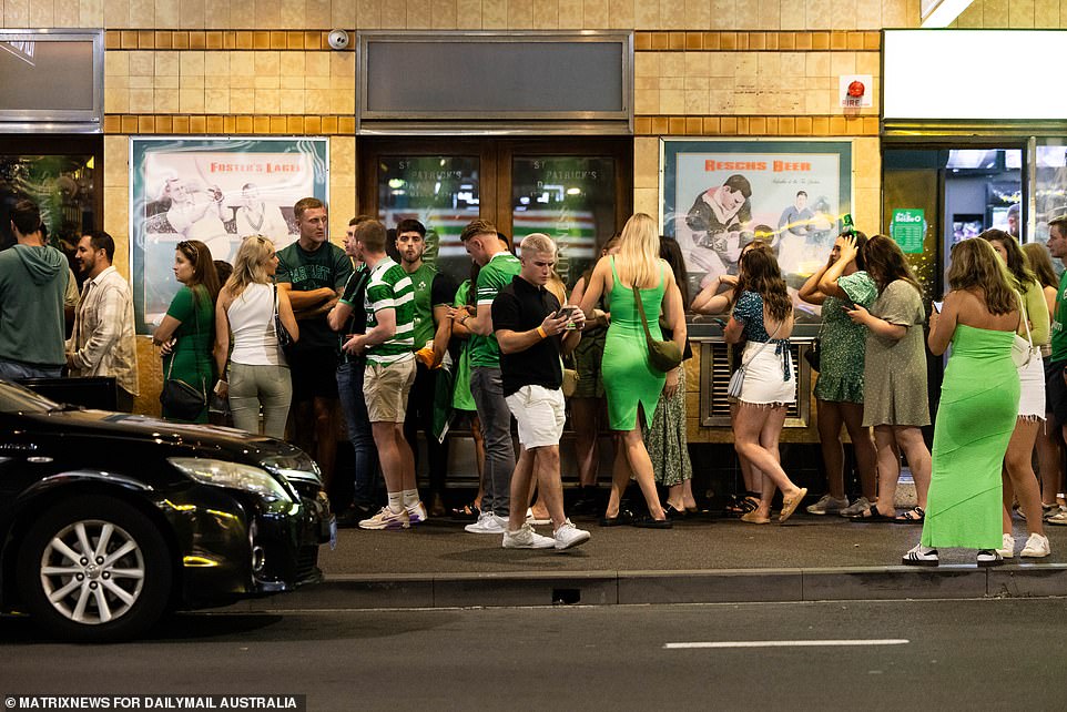 Partygoers were seen waiting patiently in long queues outside a pub in Sydney