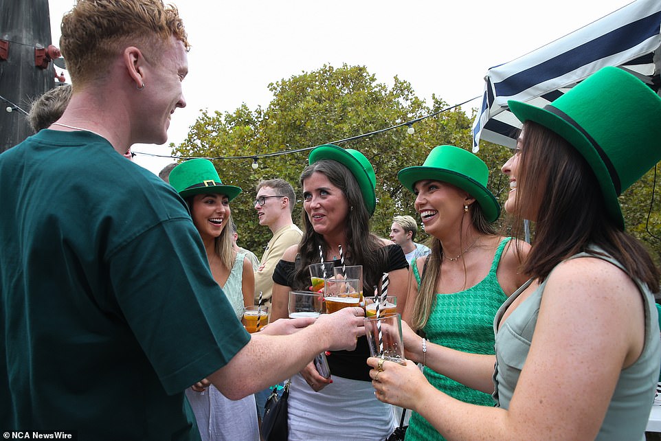 Some wore oversized new green hats as they enjoyed a beer at Sydney's Glenmore Hotel in the Rocks
