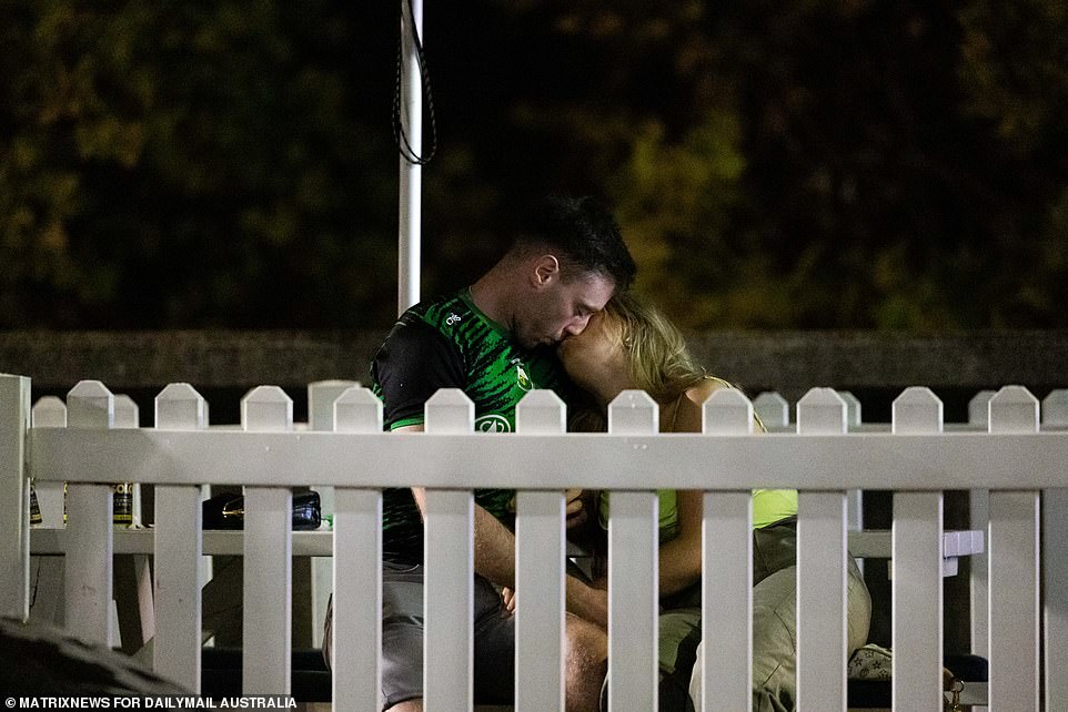 A couple is pictured sharing a quiet moment during the riotous St. Patrick's Day festivities