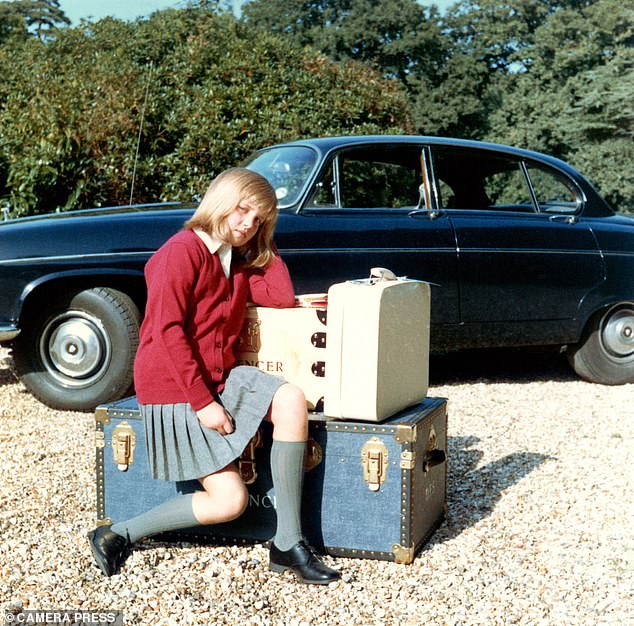 Diana told her father she didn't want to go to boarding school, but instead he took this photo of his daughter, sitting on a trunk in her pleated skirt and red vest, school uniform