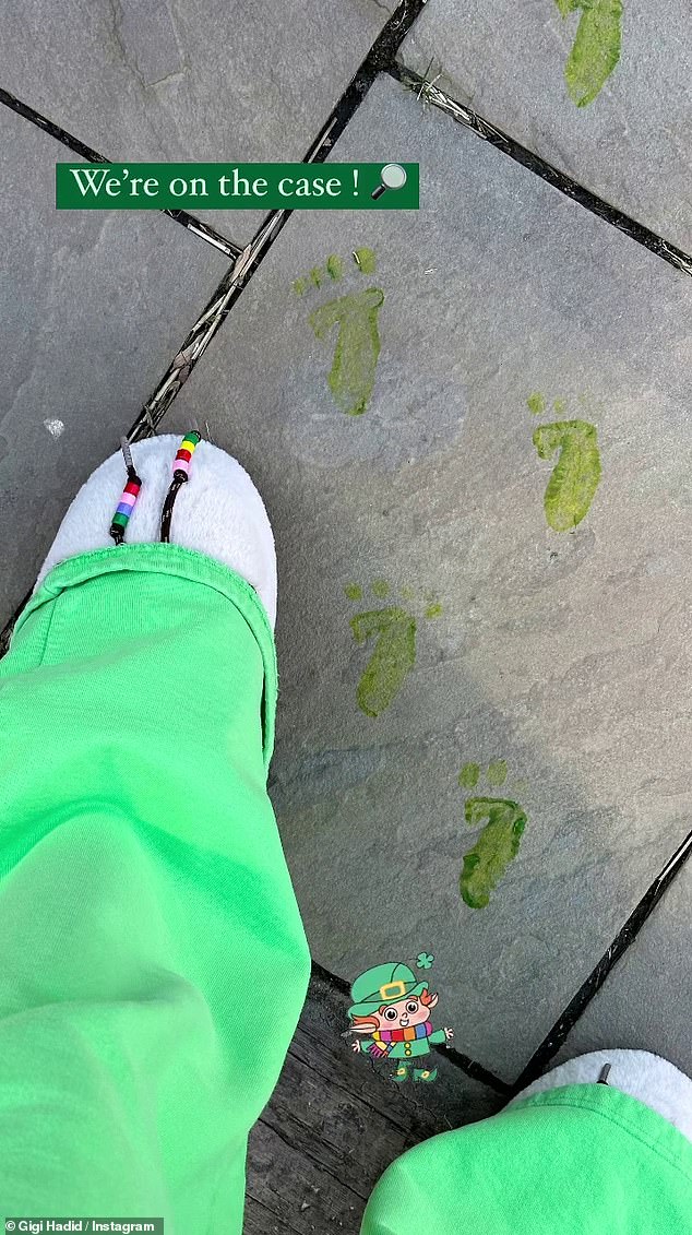 Gigi Hadid, 28, shared a sweet photo of daughter Khai's feet next to some small green footprints on the sidewalk.  The three-year-old wore green trousers and white slippers as she tried to track down a gnome.  