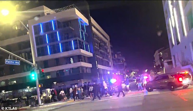 Police patrol cars can be seen on the roads outside the mall on Saturday evening