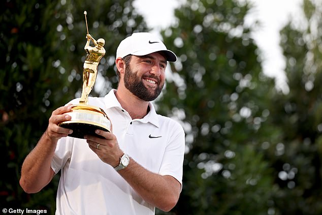 Scottie Scheffler celebrates with the trophy after winning the final round at the Players